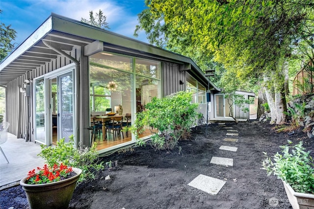 5 Wembley Ln, Mercer Island, WA 98040 - view of property exterior with a wooden deck, a sunroom, and board and batten siding