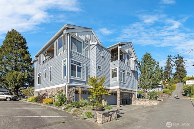 656 Daley St Unit 102, Edmonds, WA 98020 - view of side of property featuring stone siding and an attached garage