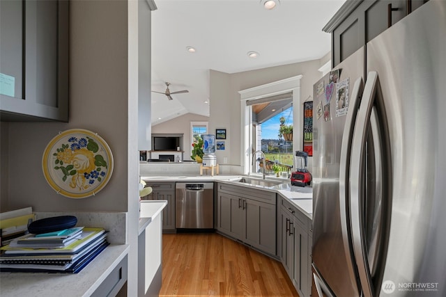 656 Daley St Unit 102, Edmonds, WA 98020 - kitchen featuring stainless steel appliances, gray cabinets, light countertops, lofted ceiling, and recessed lighting