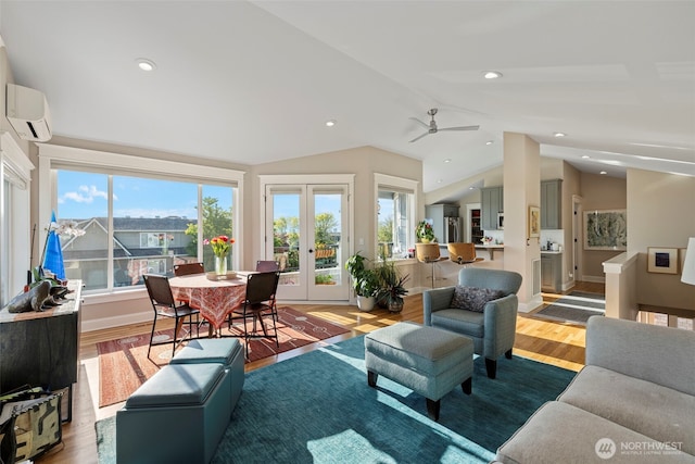 656 Daley St Unit 102, Edmonds, WA 98020 - living room with a wall mounted air conditioner, wood finished floors, vaulted ceiling, french doors, and a ceiling fan