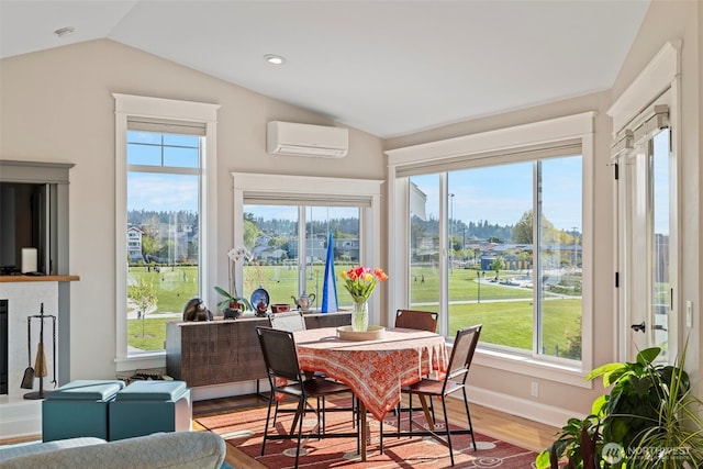 656 Daley St Unit 102, Edmonds, WA 98020 - dining room with a wall mounted AC, lofted ceiling, wood finished floors, healthy amount of natural light, and baseboards