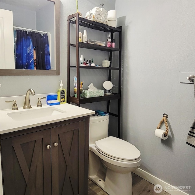 11301 199th Ave E, Bonney Lake, WA 98391 - full bath featuring wood finished floors, vanity, toilet, baseboards, and a shower with shower curtain