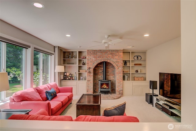 18915 SE 284th Ct, Kent, WA 98042 - living room featuring a wood stove, carpet flooring, recessed lighting, a ceiling fan, and built in features