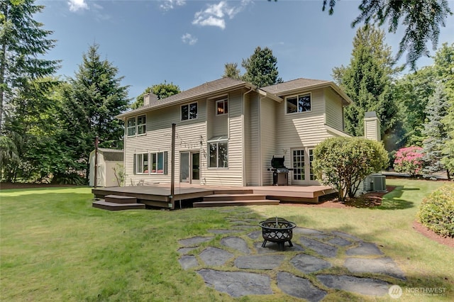18915 SE 284th Ct, Kent, WA 98042 - rear view of property with an outdoor fire pit, a chimney, a wooden deck, and a lawn