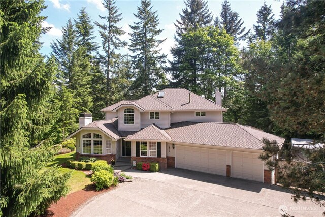 18915 SE 284th Ct, Kent, WA 98042 - view of front of property with a garage, driveway, a chimney, and brick siding