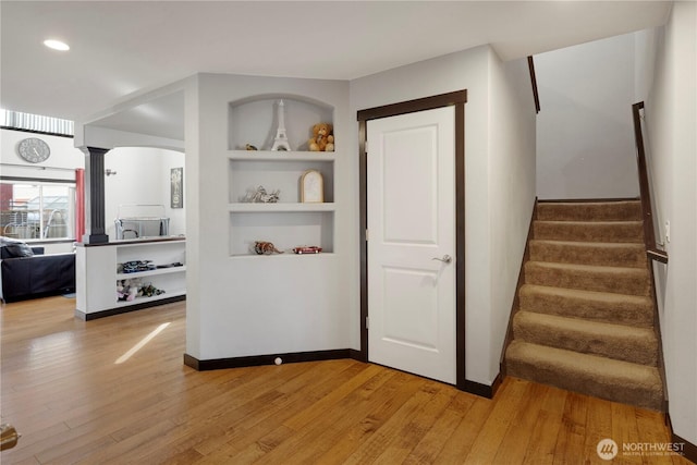 1875 Mckinley St, Ferndale, WA 98248 - stairs featuring wood finished floors, built in features, decorative columns, and recessed lighting
