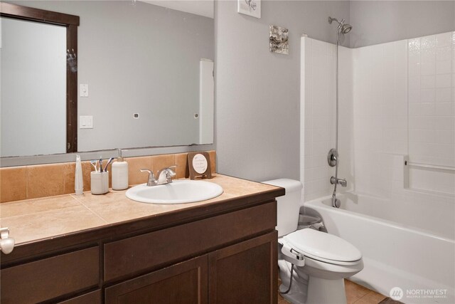 1875 Mckinley St, Ferndale, WA 98248 - bathroom with toilet, vanity, bathing tub / shower combination, and backsplash
