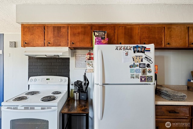 260 Baltimore St, Longview, WA 98632 - kitchen featuring white appliances, under cabinet range hood, brown cabinets, a textured ceiling, and light countertops