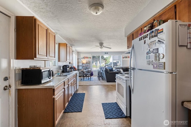 260 Baltimore St, Longview, WA 98632 - kitchen with white appliances, ceiling fan, light countertops, a sink, and brown cabinetry