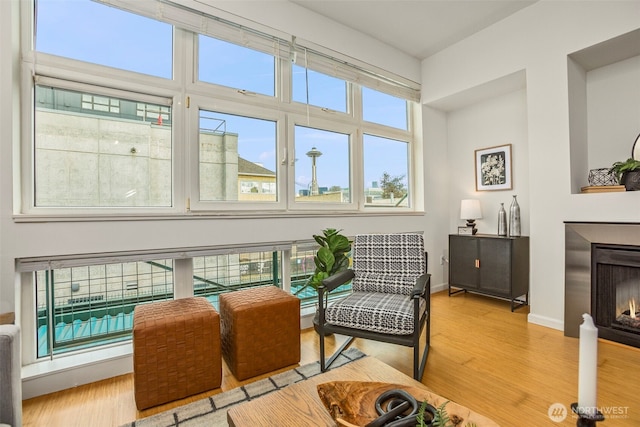 17 W Mercer St Unit 218, Seattle, WA 98119 - living area with wood finished floors, a lit fireplace, and baseboards