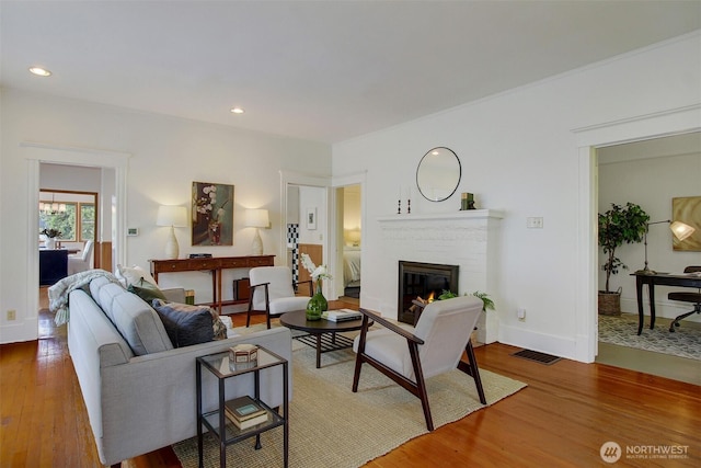 2433 E Valley St, Seattle, WA 98112 - living area with wood finished floors, a fireplace, baseboards, and recessed lighting