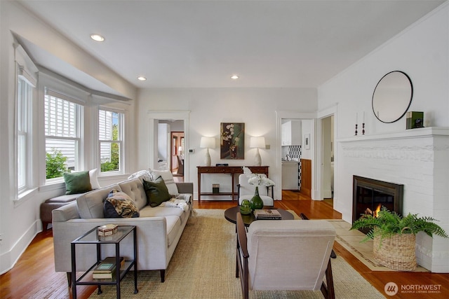 2433 E Valley St, Seattle, WA 98112 - living room with light wood-style floors, a brick fireplace, recessed lighting, and baseboards