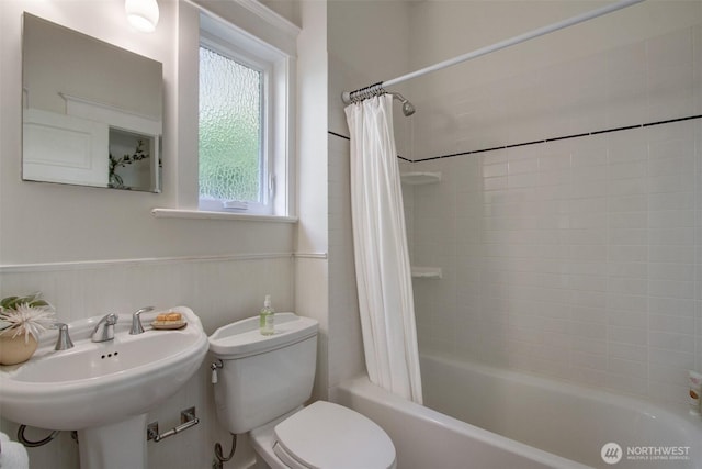 2433 E Valley St, Seattle, WA 98112 - bathroom featuring toilet, shower / bath combo with shower curtain, and a wainscoted wall