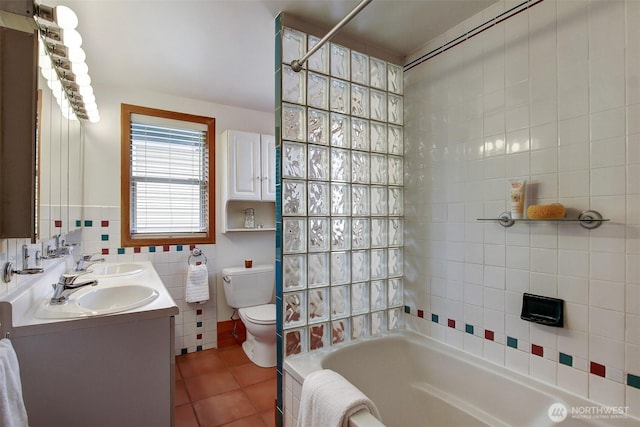 2433 E Valley St, Seattle, WA 98112 - bathroom with tile patterned floors, toilet, double vanity, shower / washtub combination, and tile walls