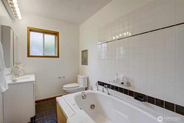 2433 E Valley St, Seattle, WA 98112 - full bathroom featuring vanity, a jetted tub, toilet, tile patterned flooring, and baseboards