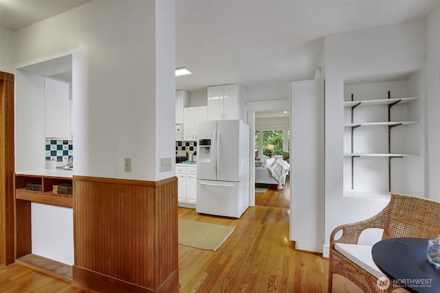 2433 E Valley St, Seattle, WA 98112 - kitchen featuring white refrigerator with ice dispenser, white cabinetry, light wood-style flooring, and light countertops