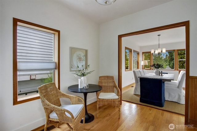 2433 E Valley St, Seattle, WA 98112 - dining area featuring a chandelier, light wood-style flooring, and baseboards