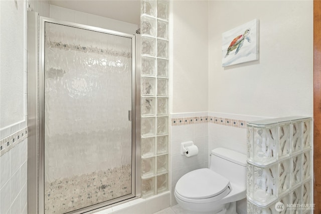 13911 Meridian Ave N, Marysville, WA 98271 - full bath featuring tile walls, a stall shower, toilet, and a wainscoted wall
