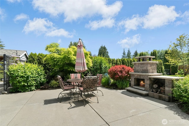 13911 Meridian Ave N, Marysville, WA 98271 - view of patio / terrace featuring an outdoor stone fireplace and outdoor dining area