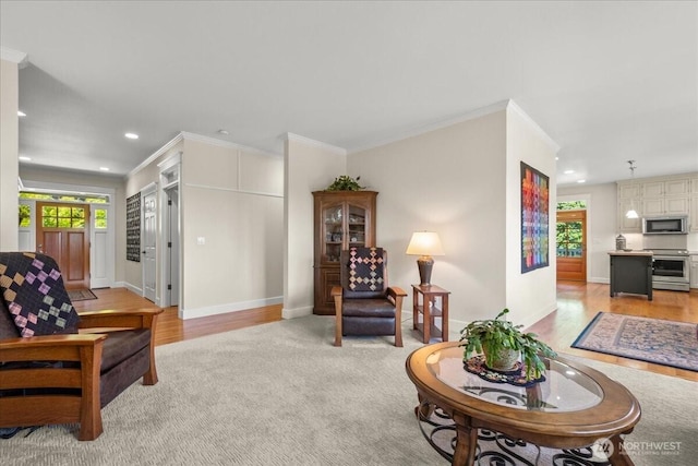 1259 Insel Rd, Woodland, WA 98674 - living room featuring crown molding, baseboards, recessed lighting, light colored carpet, and light wood-style flooring