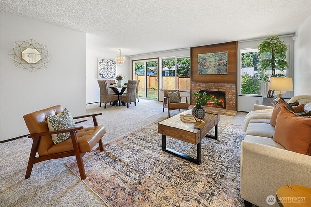 14210 NE 63rd Ct, Redmond, WA 98052 - carpeted living room featuring a textured ceiling, a fireplace, and a chandelier