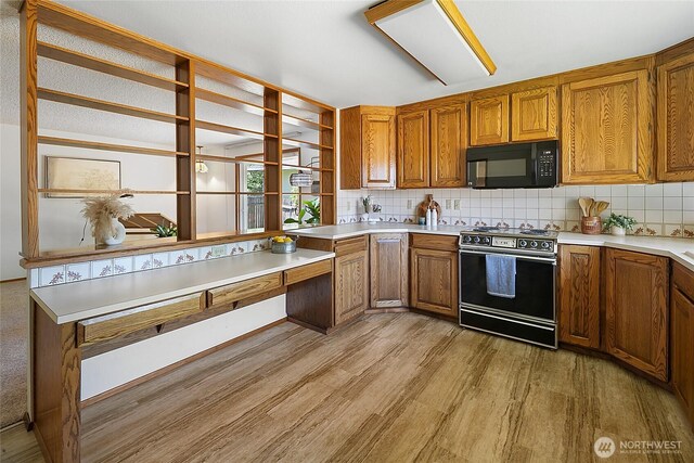 14210 NE 63rd Ct, Redmond, WA 98052 - kitchen featuring black appliances, light wood-type flooring, brown cabinetry, and tasteful backsplash