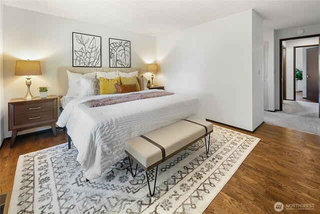 14210 NE 63rd Ct, Redmond, WA 98052 - bedroom featuring baseboards, wood finished floors, and a textured ceiling