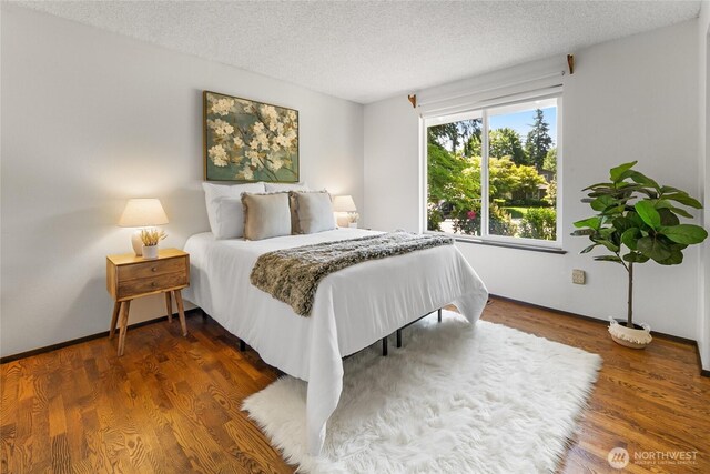 14210 NE 63rd Ct, Redmond, WA 98052 - bedroom with a textured ceiling, wood finished floors, and baseboards