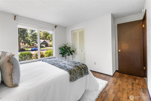 14210 NE 63rd Ct, Redmond, WA 98052 - bedroom with a textured ceiling, wood finished floors, and a closet