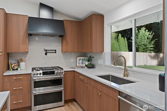 7118 177th St SW, Edmonds, WA 98026 - kitchen featuring stainless steel appliances, wall chimney range hood, a sink, tasteful backsplash, and lofted ceiling