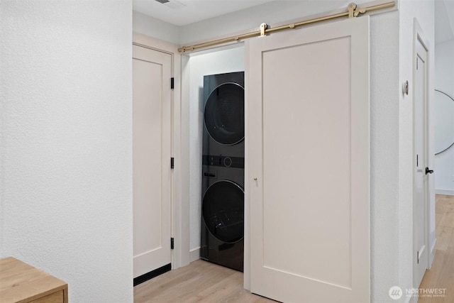 7118 177th St SW, Edmonds, WA 98026 - washroom with stacked washer / drying machine and light wood-style floors