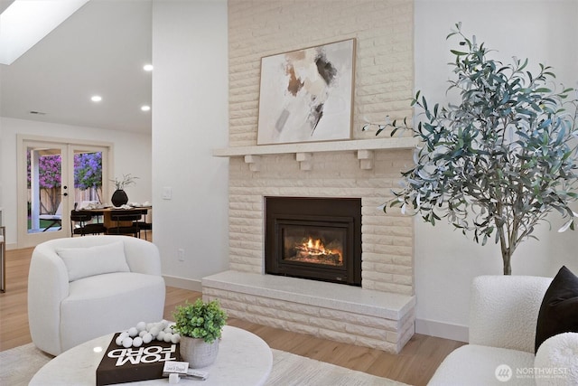 7118 177th St SW, Edmonds, WA 98026 - living area with wood finished floors, recessed lighting, a brick fireplace, baseboards, and lofted ceiling