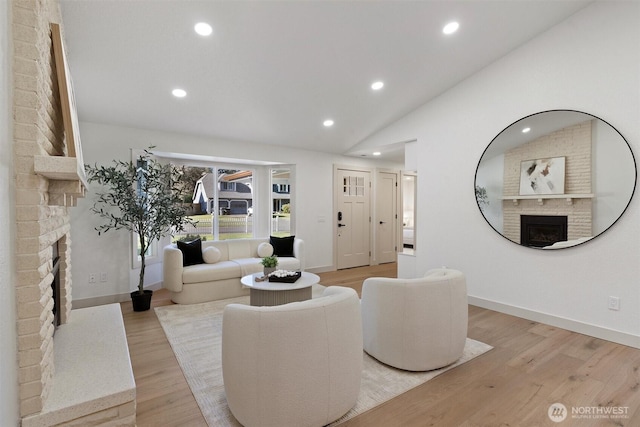 7118 177th St SW, Edmonds, WA 98026 - living area with a fireplace, recessed lighting, light wood-style floors, vaulted ceiling, and baseboards