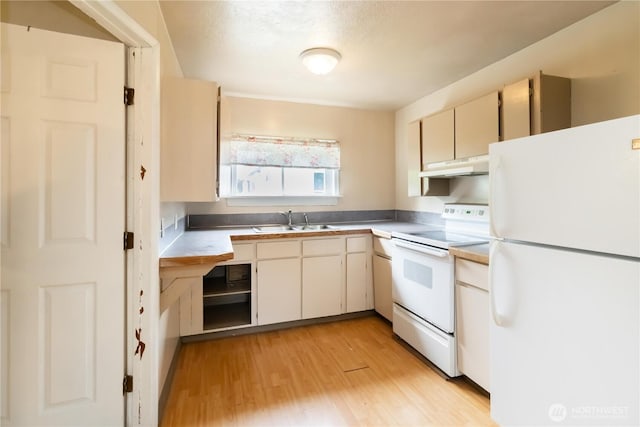 611 NE Pioneer, Castle Rock, WA 98611 - kitchen with white appliances, a sink, under cabinet range hood, light wood-style flooring, and light countertops