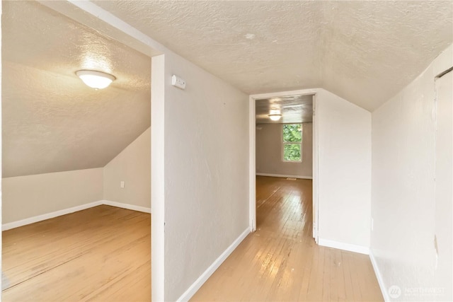 611 NE Pioneer, Castle Rock, WA 98611 - bonus room with a textured ceiling, wood-type flooring, lofted ceiling, and baseboards