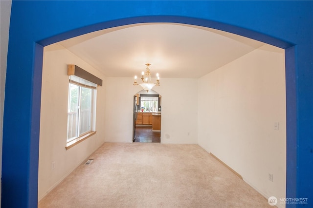 19011 89th Ave E, Puyallup, WA 98375 - carpeted spare room featuring a chandelier and arched walkways
