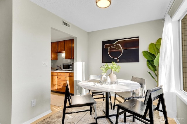 14513 127th Ln NE Unit N46, Kirkland, WA 98034 - dining room featuring baseboards and light wood-type flooring