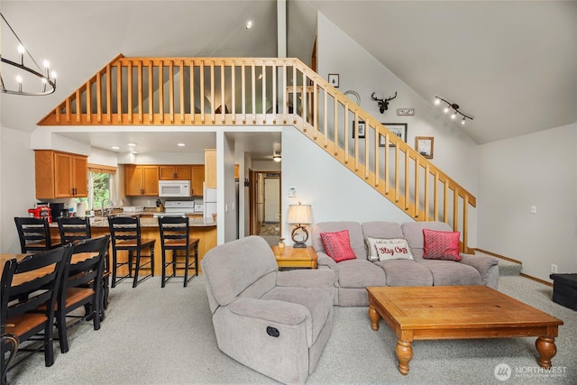 1051 Yellowstone, Snoqualmie Pass, WA 98068 - living area featuring high vaulted ceiling, light colored carpet, stairs, and a chandelier