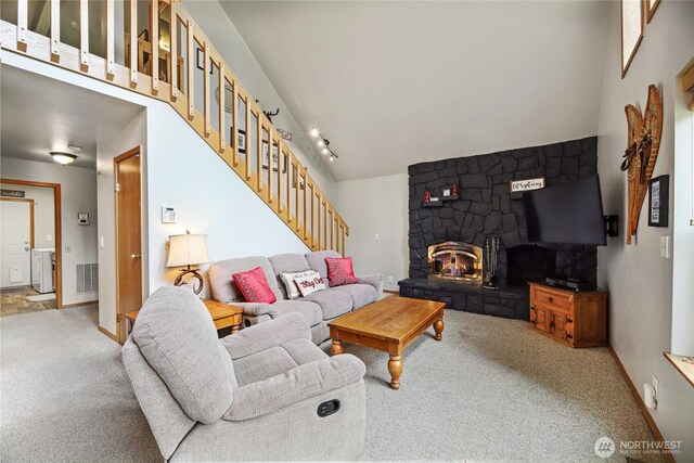 1051 Yellowstone, Snoqualmie Pass, WA 98068 - living room with light carpet, stairway, a stone fireplace, lofted ceiling, and baseboards