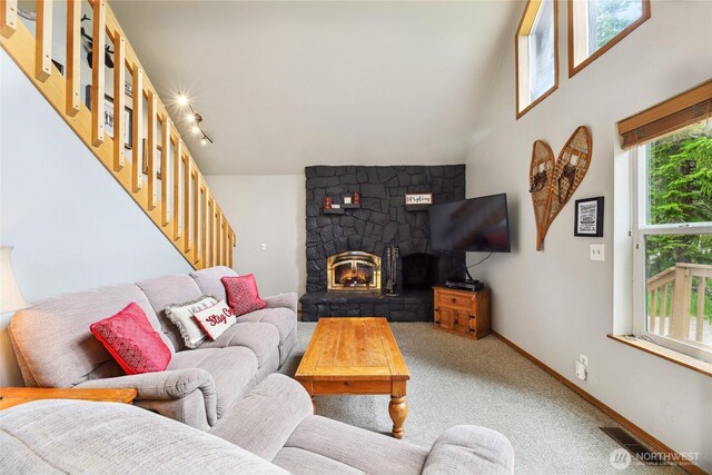 1051 Yellowstone, Snoqualmie Pass, WA 98068 - living room featuring stairs, light carpet, a stone fireplace, and baseboards