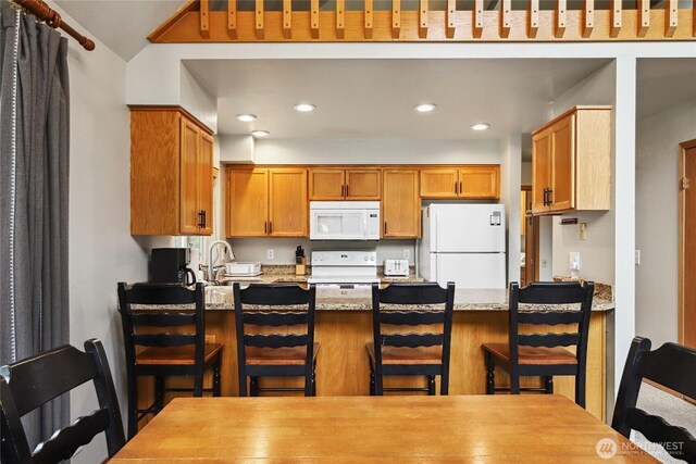 1051 Yellowstone, Snoqualmie Pass, WA 98068 - kitchen featuring white appliances, a peninsula, recessed lighting, light stone countertops, and a sink