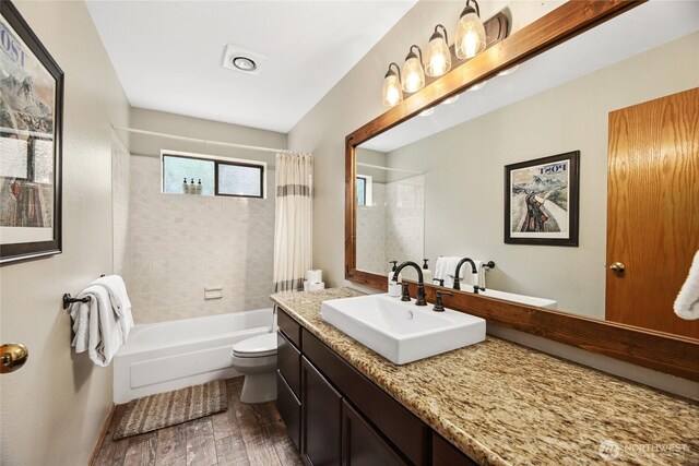 1051 Yellowstone, Snoqualmie Pass, WA 98068 - bathroom featuring toilet, vanity, wood finished floors, and shower / bathtub combination with curtain