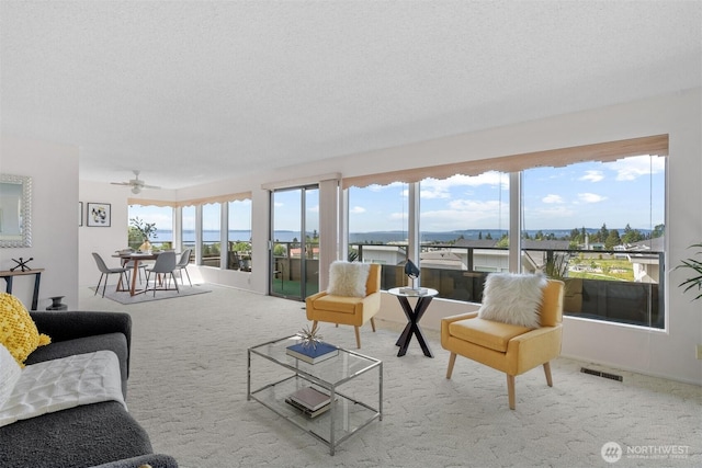 655 Main St Unit 304, Edmonds, WA 98020 - carpeted living room with plenty of natural light, a ceiling fan, and a textured ceiling