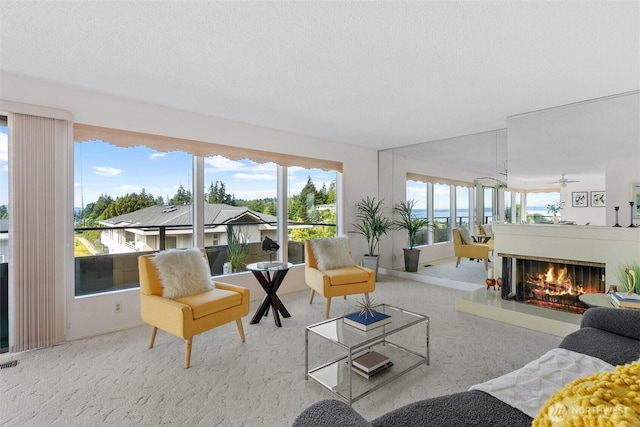 655 Main St Unit 304, Edmonds, WA 98020 - living area with a glass covered fireplace, a ceiling fan, and carpet floors