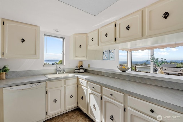 655 Main St Unit 304, Edmonds, WA 98020 - kitchen with dishwasher, a sink, plenty of natural light, and light countertops