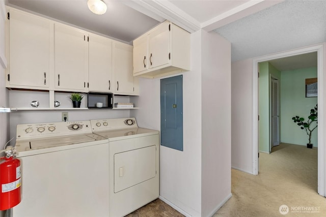 655 Main St Unit 304, Edmonds, WA 98020 - laundry room featuring washing machine and dryer, cabinet space, electric panel, light colored carpet, and baseboards