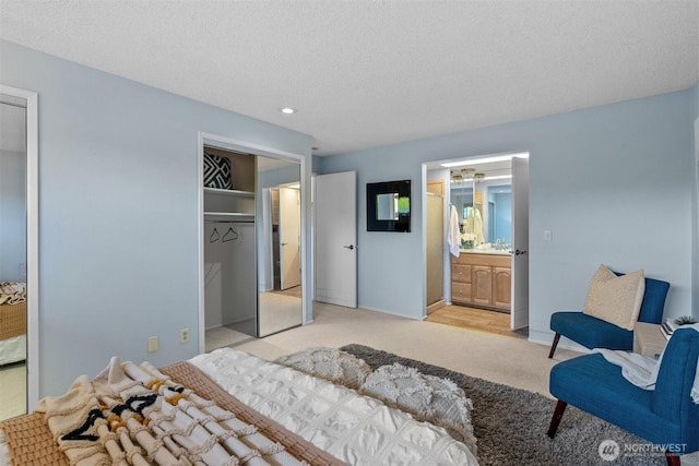 655 Main St Unit 304, Edmonds, WA 98020 - bedroom with light colored carpet, recessed lighting, a textured ceiling, baseboards, and connected bathroom