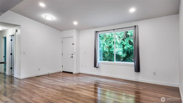22470 Sunridge Way NE, Poulsbo, WA 98370 - unfurnished room with wood finished floors, baseboards, and recessed lighting