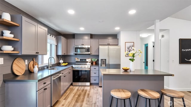 22470 Sunridge Way NE, Poulsbo, WA 98370 - kitchen with stainless steel appliances, a sink, dark countertops, open shelves, and light wood finished floors