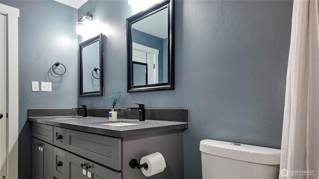 22470 Sunridge Way NE, Poulsbo, WA 98370 - bathroom with toilet, double vanity, and a textured wall